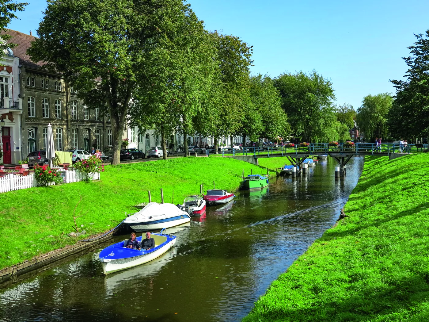 Grachtenartiger Kanal mit Booten und grünen Uferböschungen in Friedrichstadt Grachtenartiger Kanal mit Booten und grünen Uferböschungen in Friedrichstadt